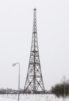 a large open-frame tower in a field