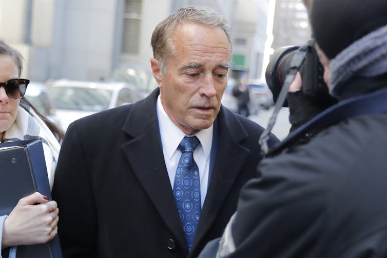 Chris Collins arrives at a federal court as cameras record him