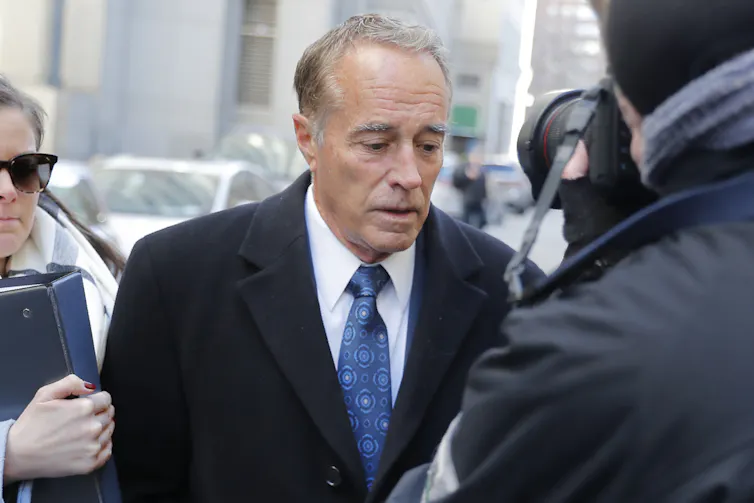 Chris Collins arrives at a federal court as cameras record him
