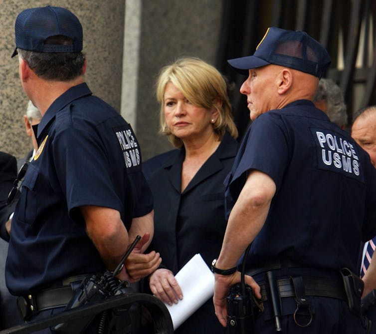 Martha Stewart, flanked by U.S. Marshals, leaves court