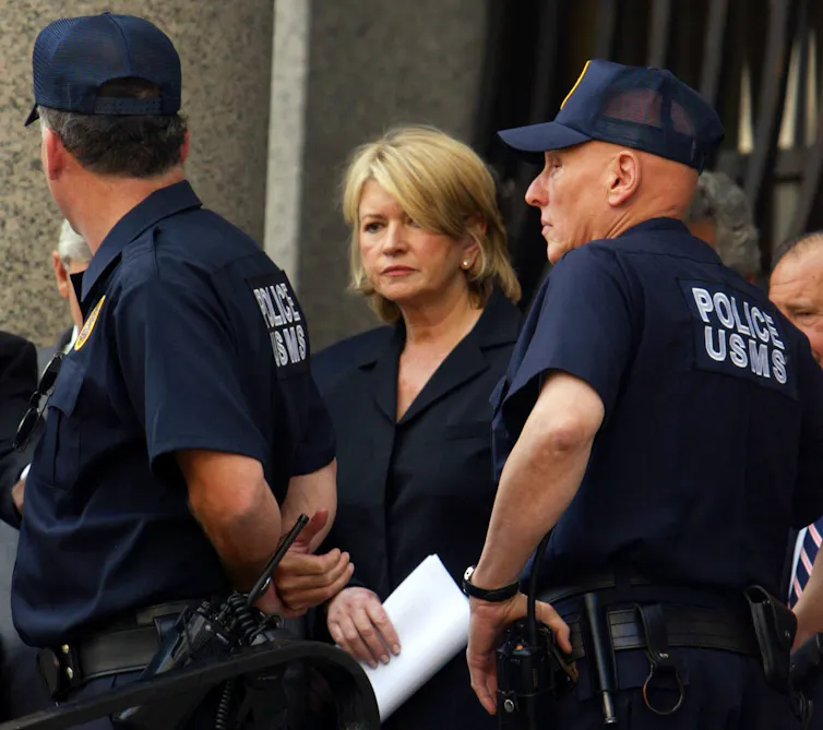 Martha Stewart, flanked by U.S. Marshals, leaves court
