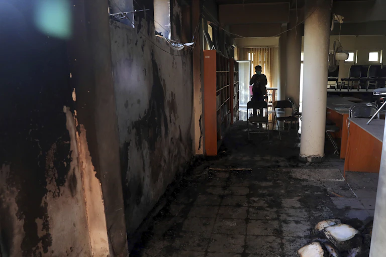 A silhouette is seen against a hallway.