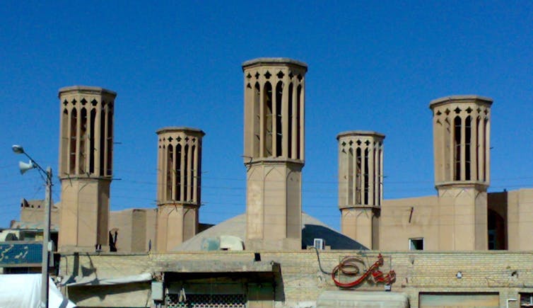 Windcatcher towers against blue sky