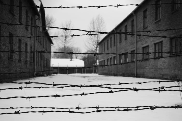 A black and white picture of one the yards in Auschwitz concentration camp in Poland.