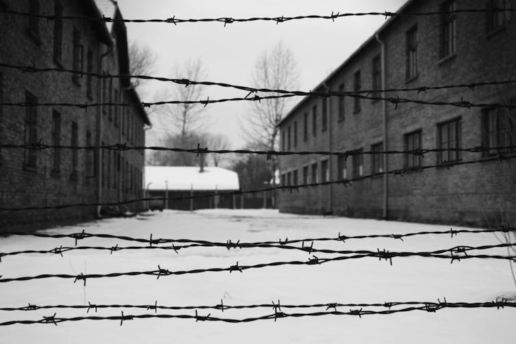A black and white picture of one the yards in Auschwitz concentration camp in Poland.
