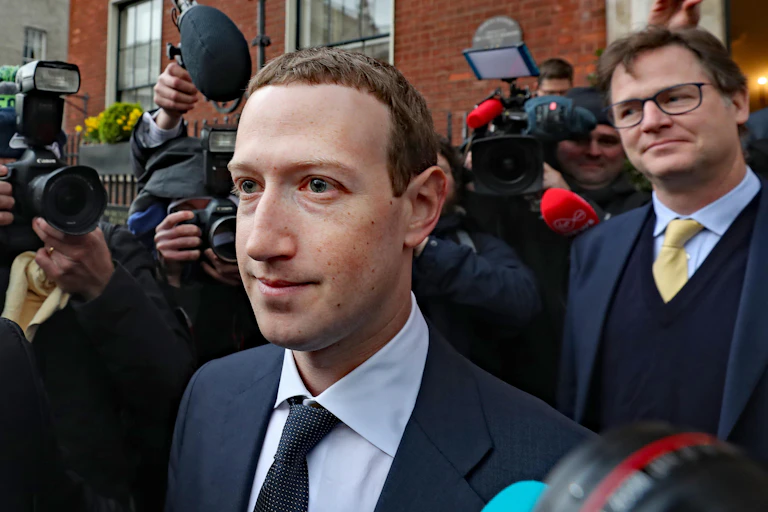 Mark Zuckerberg being surrounded by the media, with Nick Clegg standing behind him