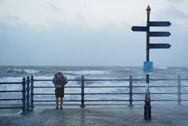 Daft man in front of storm sea