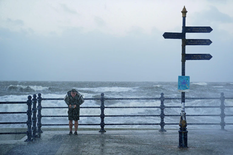 Daft man in front of storm sea