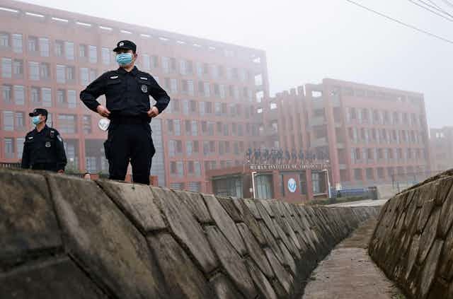  Security personnel keep watch outside Wuhan Institute of Virology during the visit by the World Health Organization (WHO) team tasked with investigating the origins of the coronavirus disease (COVID-19), in Wuhan, Hubei province, China February 3, 2021. REUTERS/Thomas Peter Stock Photo Download preview Save to lightbox Add to cart  Share   Security personnel keep watch outside Wuhan Institute of Virology