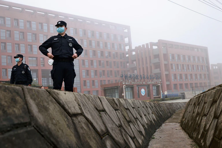 Security personnel keep watch outside Wuhan Institute of Virology during the visit by the World Health Organization (WHO) team tasked with investigating the origins of the coronavirus disease (COVID-19), in Wuhan, Hubei province, China February 3, 2021. REUTERS/Thomas Peter Stock Photo Download preview Save to lightbox Add to cart Share Security personnel keep watch outside Wuhan Institute of Virology