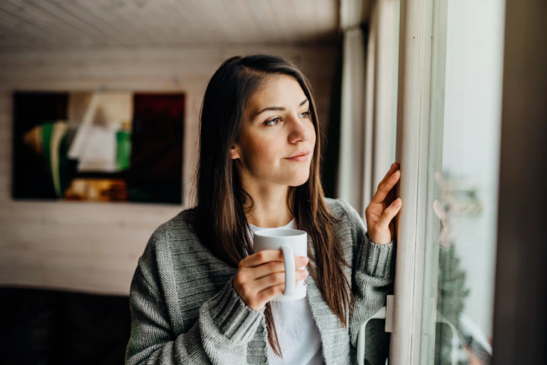 A person isolating looking out of the window