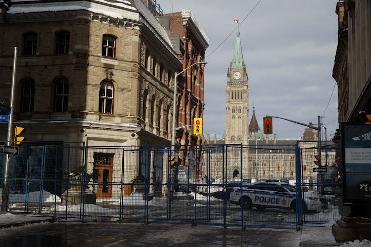 The Parliament buildings are seen behind a fence.