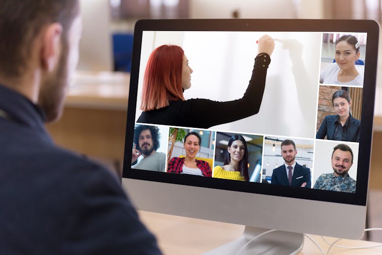 Virtual meeting with a few people on a screen.
