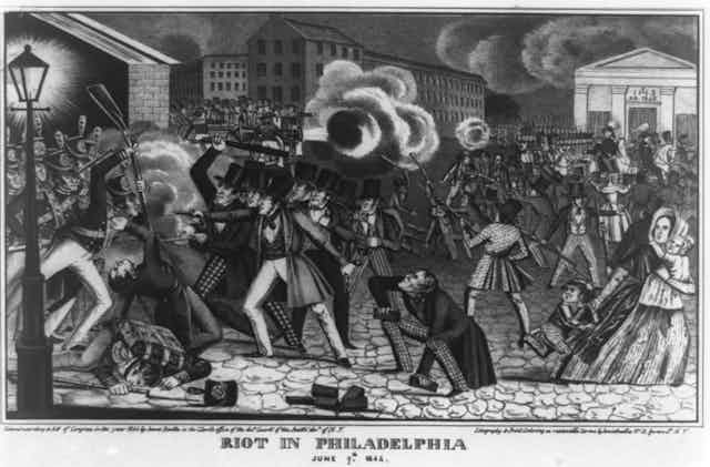 An ink illustration of a city street with people fighting