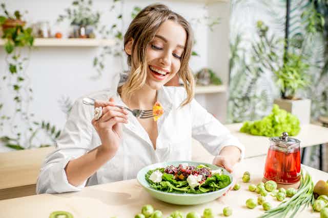 Young female eating a healthy salad