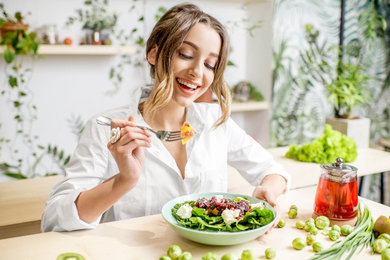 Young female eating a healthy salad