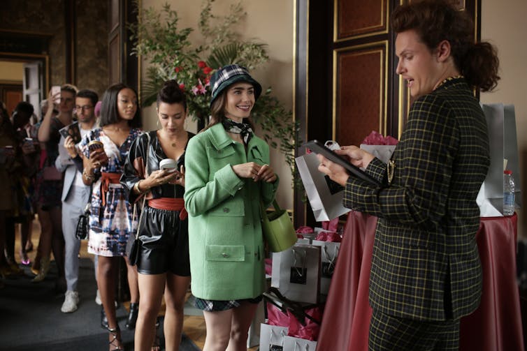 Line of women wait to be let into a fashion event.