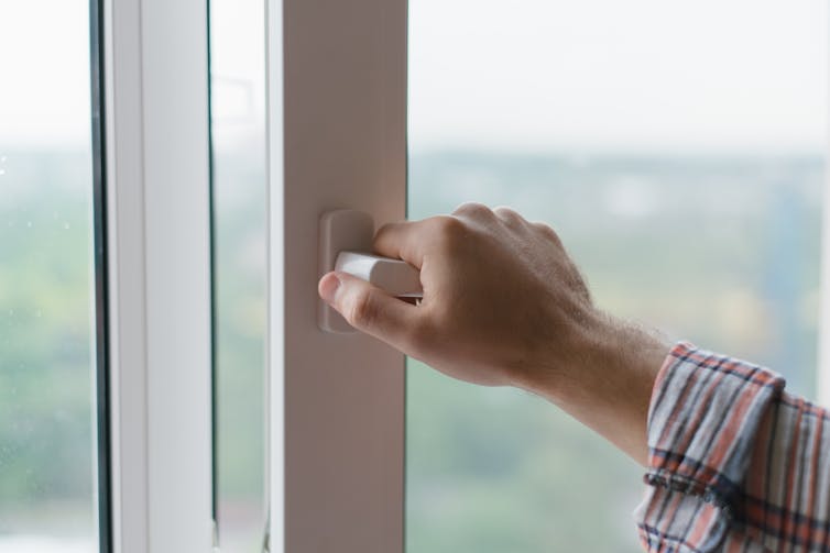 Man opens window.