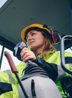 Woman driving a crane.