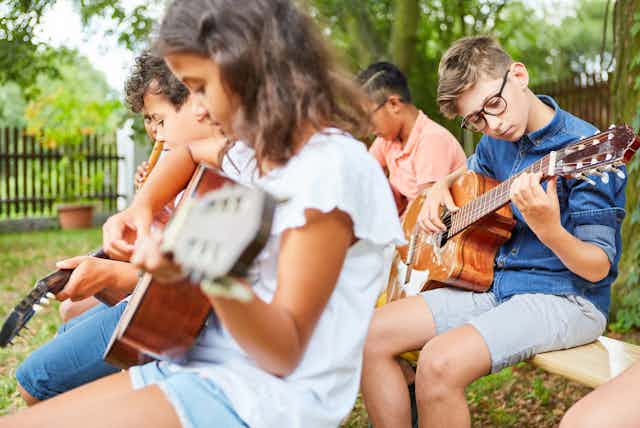 Group of children playing guitars