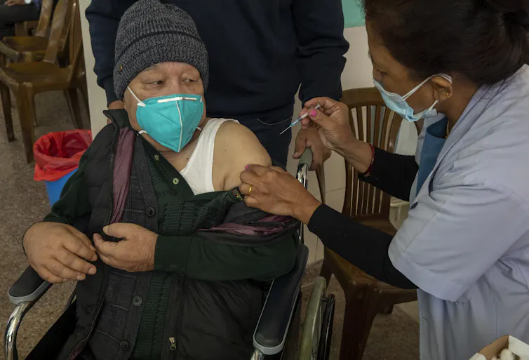 A COVID vaccine being given in Nepal