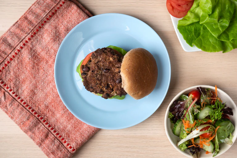 Hamburger contenant des haricots et une salade