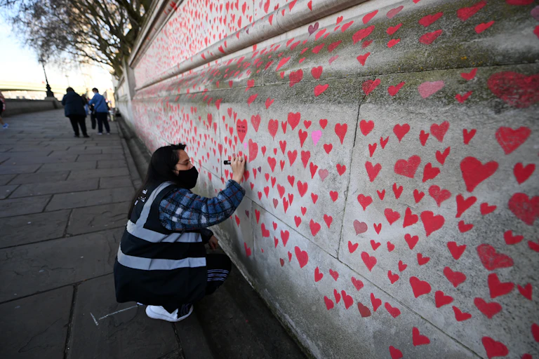 Volunteer working on National Covid Memorial Wall in London