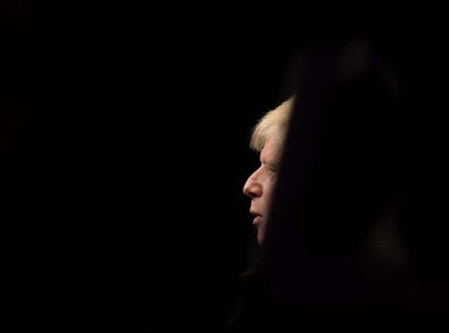 A profile of Boris Johnson in the middle of a completely black background.