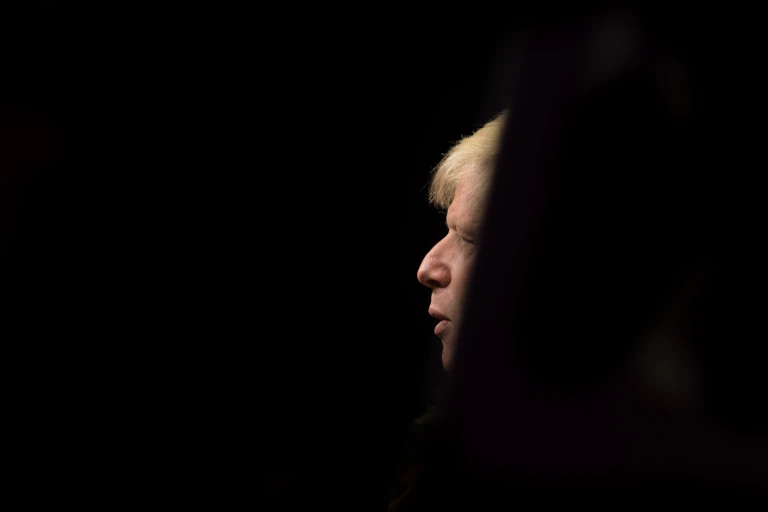 A profile of Boris Johnson in the middle of a completely black background.