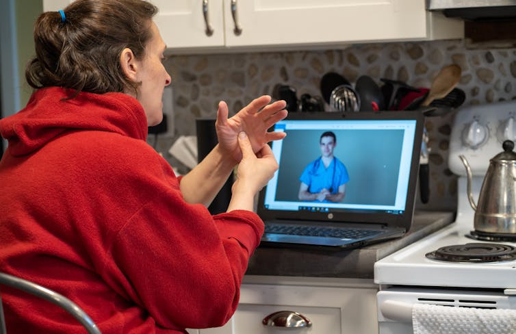 Woman consults a doctor via telehealth.