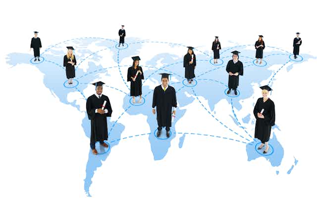 People in academic gowns and mortarboards standing on the continents of the world