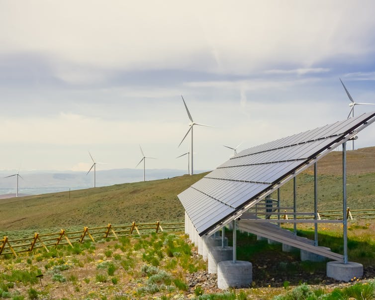 Solar panels with wind turbines