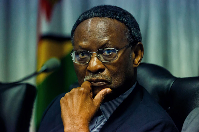 A man on grey suit, listening attentively