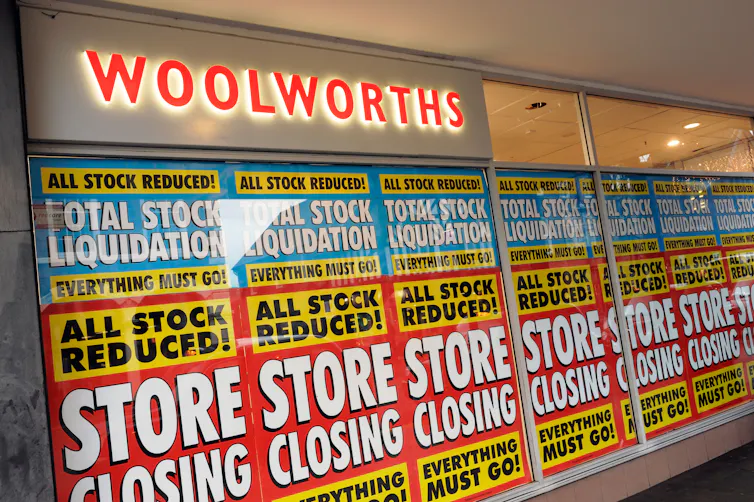 Shop window closing down signs.