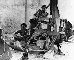 A black and white photo of Cuban soldiers resting.