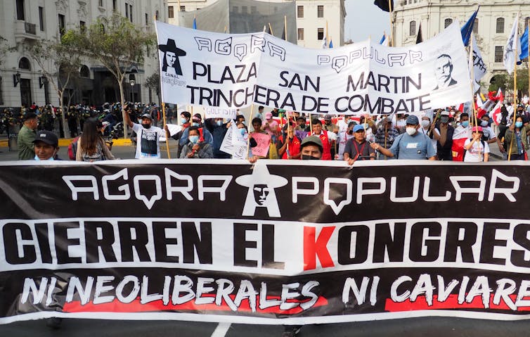 A Peruvian protest with a banner that called for closing that country's congress.