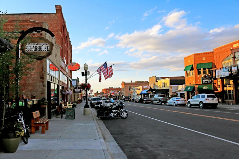 A landscape of a small town square filled with restaurants and stores.