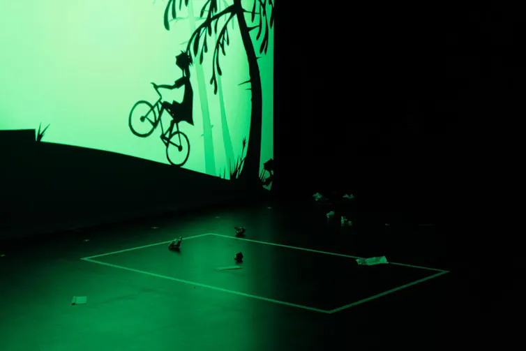 Shadow puppet of a girl on a bike