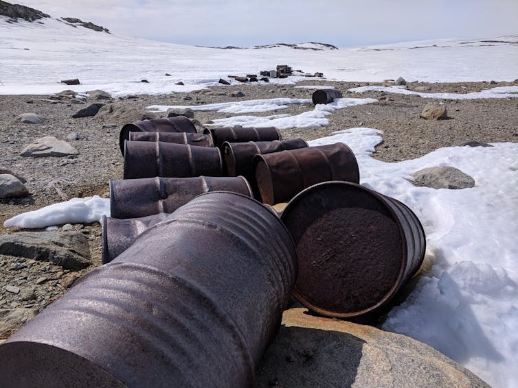Rusted oil barrels on the soil near Wilkes Station