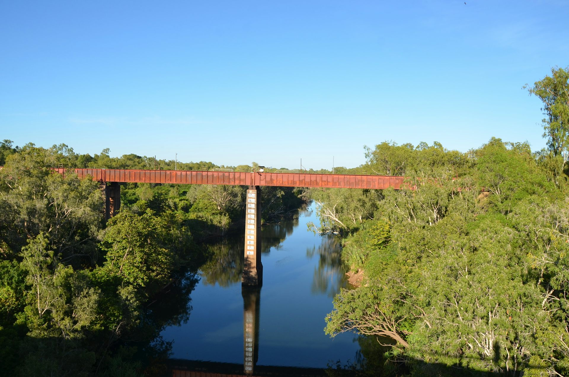 A bridge across a river with a flood gauge visible