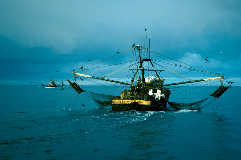 Trawler boat at sea, gloomy sky