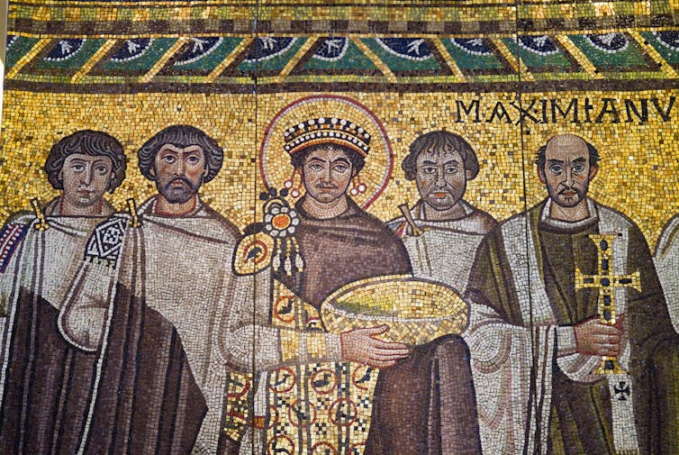 A mosaic showing Roman Emperor Justinian flanked by two men on either side.