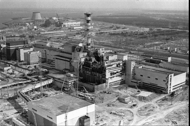 A black and white photo showing an aerial view of a damaged industrial site.