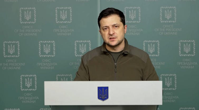 Ukraine's president Volodymyr Zelensky speaks from a podium.