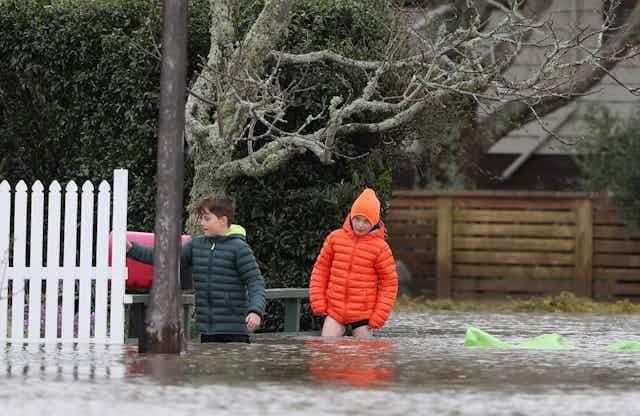 Kids wading in flood waters.