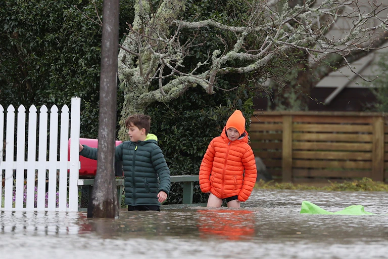 Kids wading in flood waters.