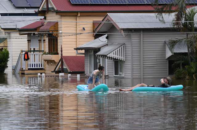 couple of floating dinghies in flood waters