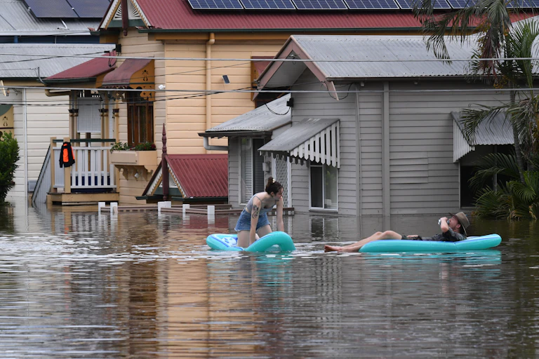 couple of floating dinghies in flood waters
