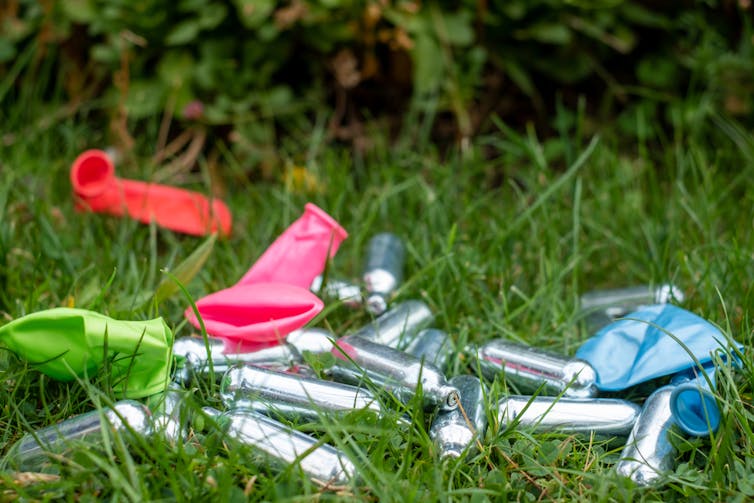 Discarded nitrous oxide canisters and the balloons used to 'huff' them.