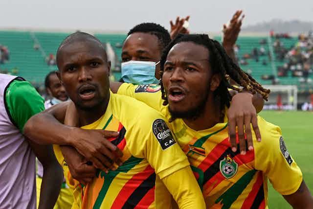 Zimbabwean national football players celebrate a goal